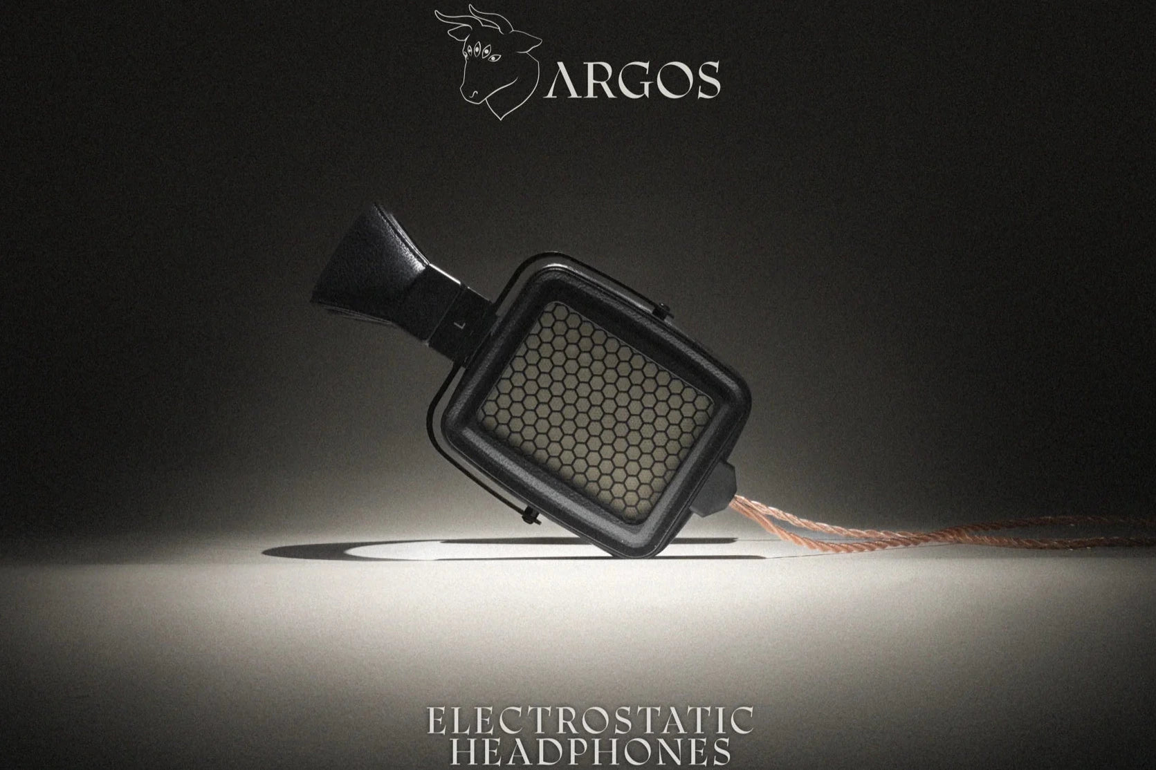Argos electrostatic headphone driver or speaker component shown at an angle on a dark studio background, with the Argos logo at the top and the text 'ELECTROSTATIC HEADPHONES' at the bottom.